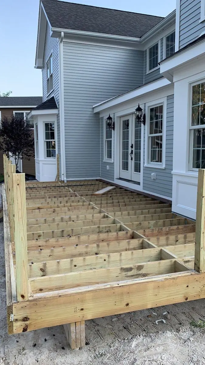 New pressure-treated deck framing built by PRC Group carpenters at a Massachusetts home