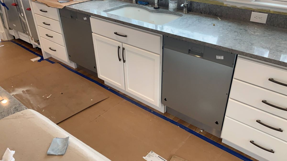 Kitchen remodel in progress with new white shaker cabinets, granite countertop and undermount sink — PRC Group, Massachusetts